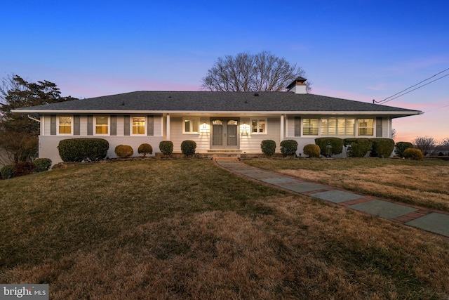 single story home featuring a front yard and a chimney