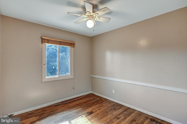 spare room featuring wood-type flooring and ceiling fan