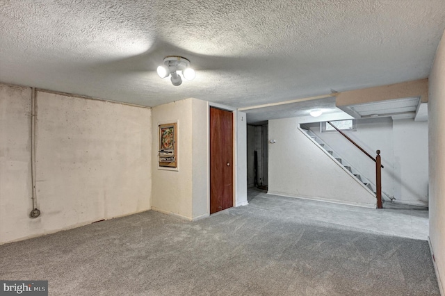 basement with carpet floors and a textured ceiling