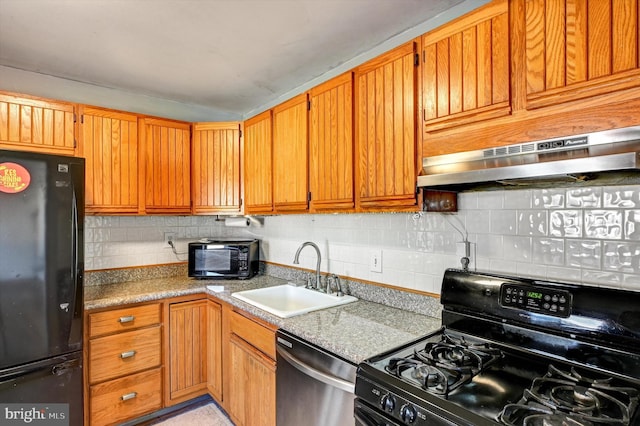 kitchen with sink, backsplash, light stone counters, and black appliances