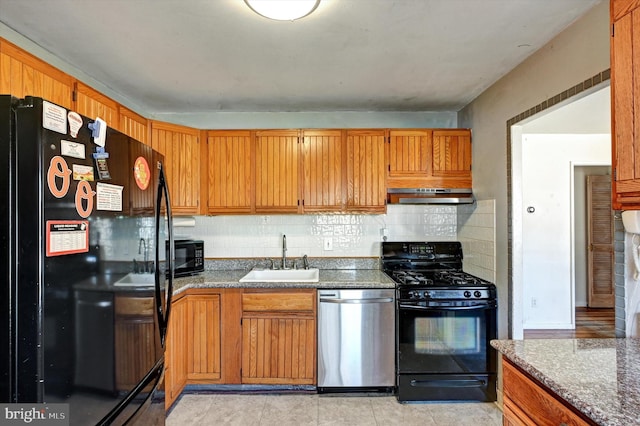 kitchen featuring tasteful backsplash, sink, and black appliances