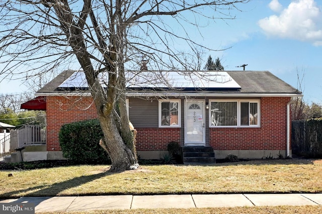 bungalow-style house featuring a front lawn