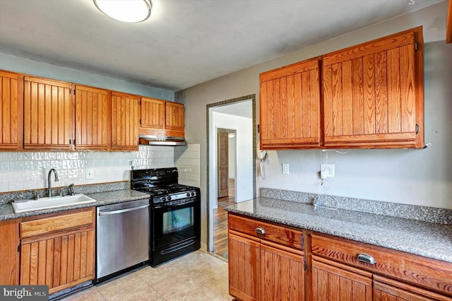 kitchen featuring black gas range oven, stone countertops, dishwasher, sink, and decorative backsplash