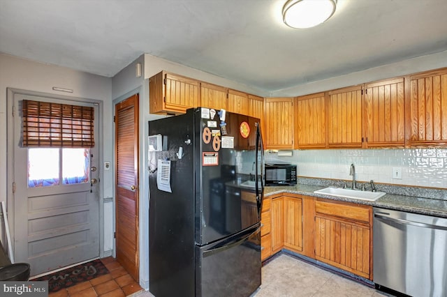 kitchen featuring tasteful backsplash, sink, and black appliances