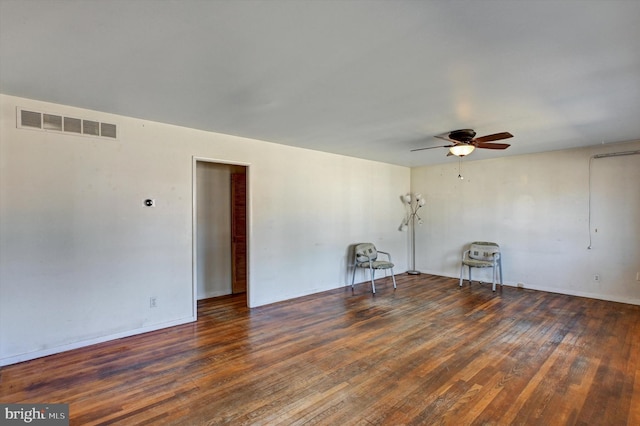 empty room featuring dark hardwood / wood-style flooring and ceiling fan