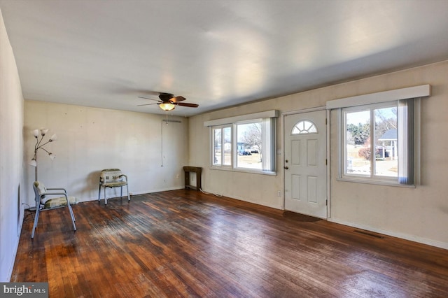 entryway featuring dark wood-type flooring, ceiling fan, and a healthy amount of sunlight