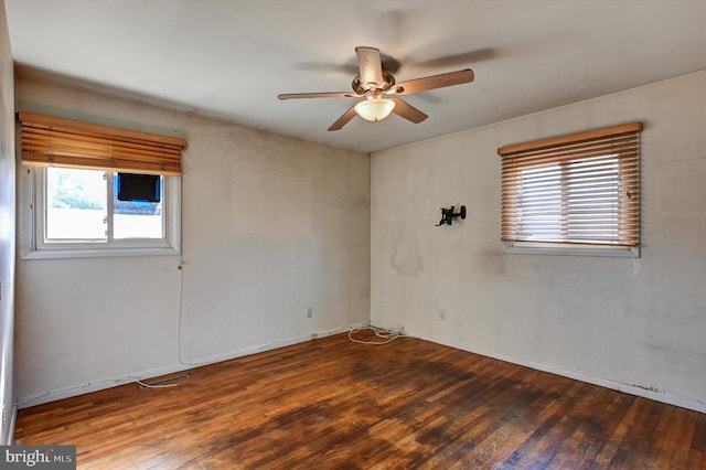 spare room featuring hardwood / wood-style flooring, plenty of natural light, and ceiling fan