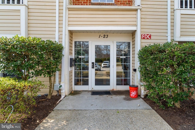 doorway to property with french doors and brick siding