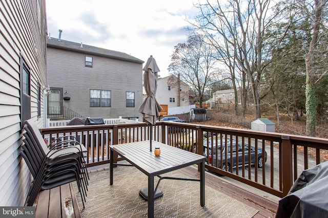 deck with a grill and a storage unit