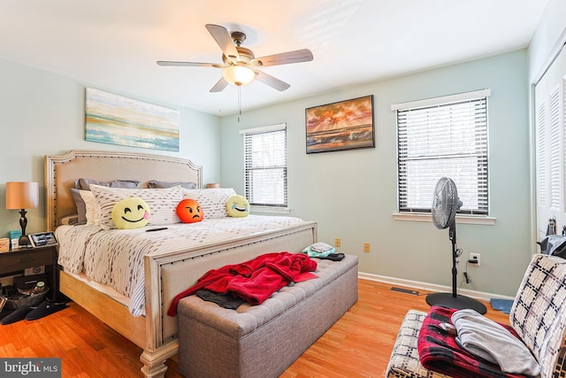 bedroom with light hardwood / wood-style floors and ceiling fan