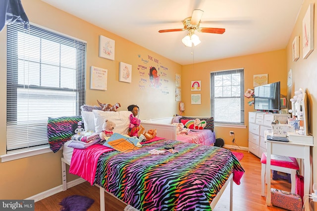 bedroom with ceiling fan and light hardwood / wood-style flooring