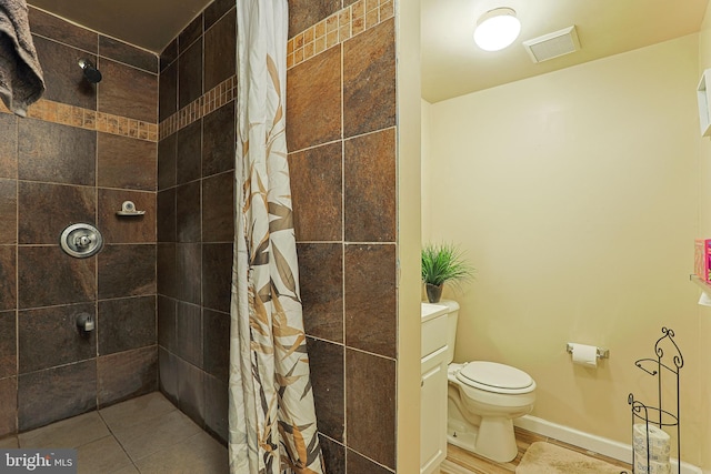 bathroom featuring vanity, toilet, and curtained shower