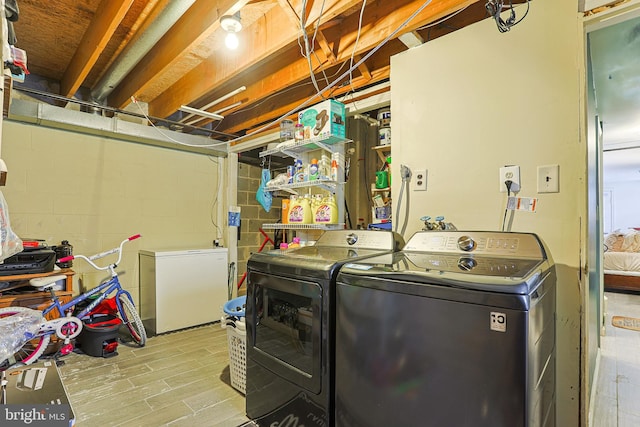 clothes washing area with washing machine and clothes dryer