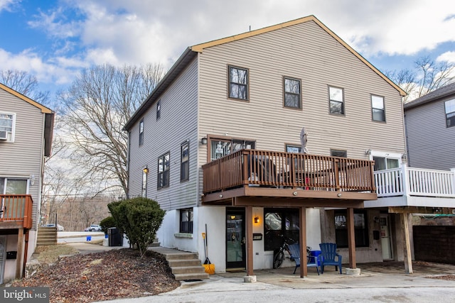 back of property with a wooden deck