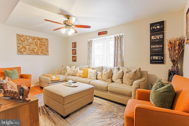 living room featuring light hardwood / wood-style floors and ceiling fan