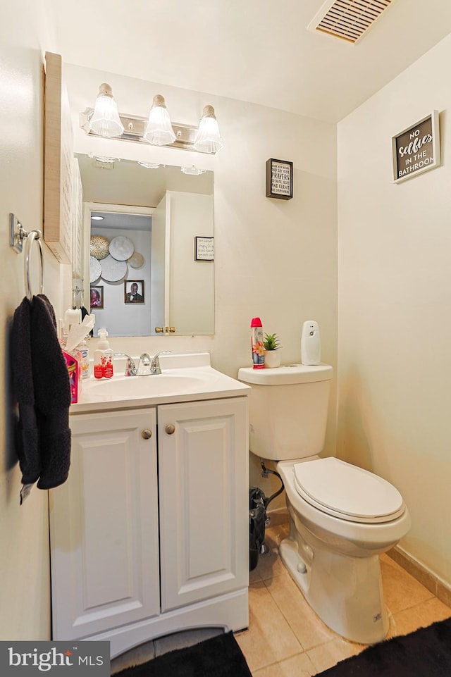 bathroom with vanity, tile patterned floors, and toilet