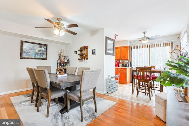 dining space featuring ceiling fan and light wood-type flooring