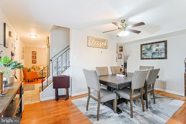 dining area with ceiling fan and light wood-type flooring