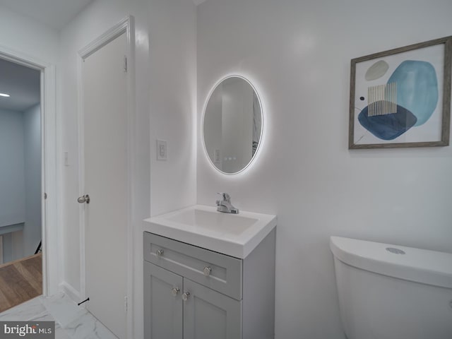 bathroom featuring vanity and toilet