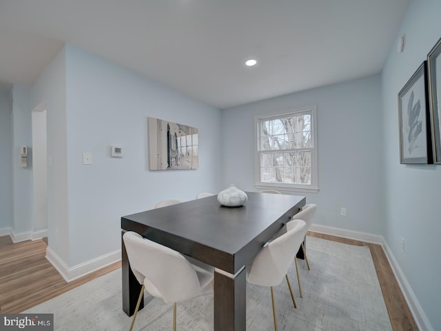 dining space with light hardwood / wood-style flooring