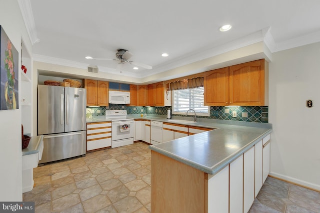 kitchen featuring crown molding, sink, white appliances, and kitchen peninsula