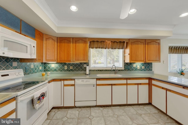 kitchen with crown molding, sink, white appliances, and decorative backsplash