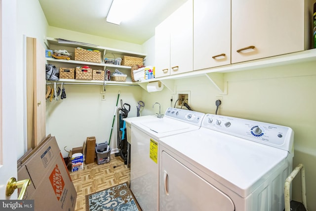 washroom featuring separate washer and dryer, cabinets, and light parquet flooring