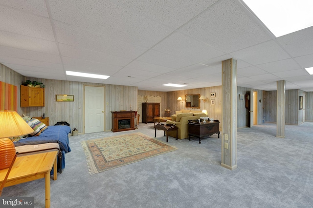 carpeted living room featuring a paneled ceiling