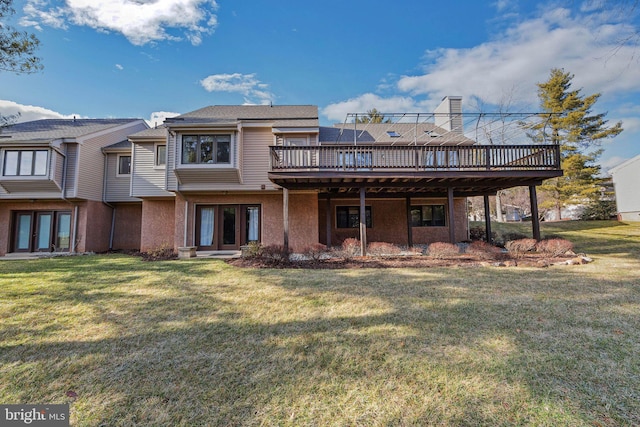 back of property featuring french doors, a yard, and a deck