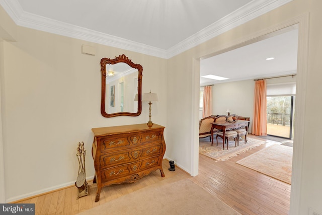 hallway featuring crown molding and light wood-type flooring