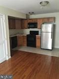 kitchen featuring dark hardwood / wood-style floors and stainless steel fridge