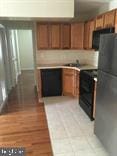 kitchen with black refrigerator, sink, and light wood-type flooring