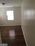 empty room with dark hardwood / wood-style floors