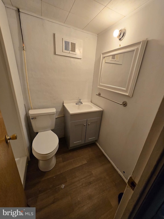 bathroom with vanity, hardwood / wood-style floors, and toilet