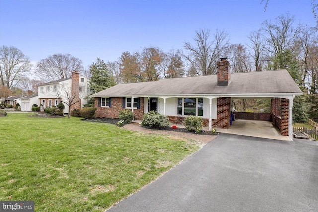 view of front facade with a front yard and a carport