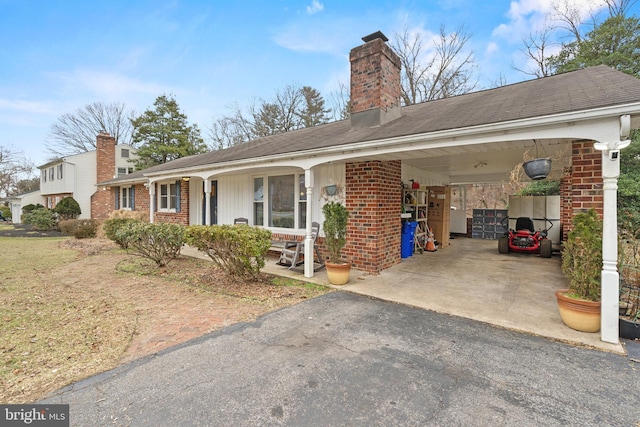 view of front facade with a carport and covered porch