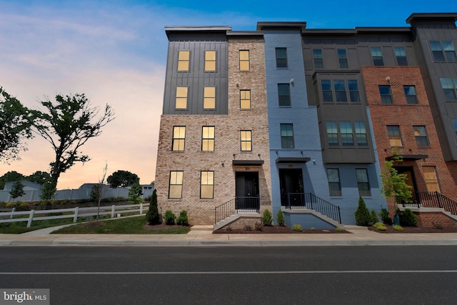 10056 American Pharoah Ln Unit 66, Laurel, MD 20723 - view of front facade featuring fence, brick siding, and board and batten siding