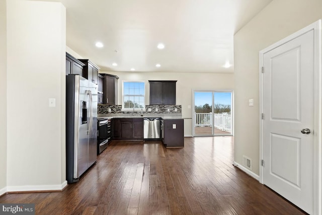 kitchen with visible vents, a healthy amount of sunlight, light countertops, appliances with stainless steel finishes, and decorative backsplash