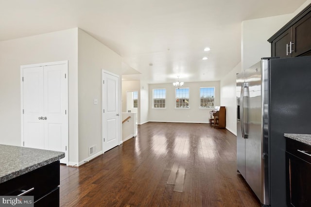 kitchen with visible vents, dark wood finished floors, light countertops, a chandelier, and stainless steel refrigerator with ice dispenser