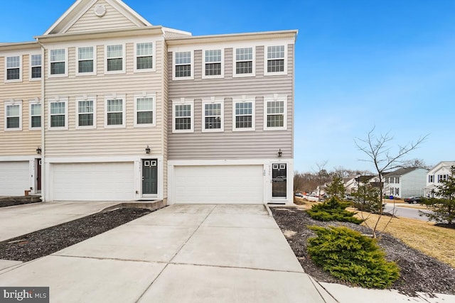 multi unit property with concrete driveway and an attached garage