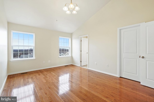 unfurnished bedroom with a chandelier, high vaulted ceiling, visible vents, baseboards, and light wood finished floors