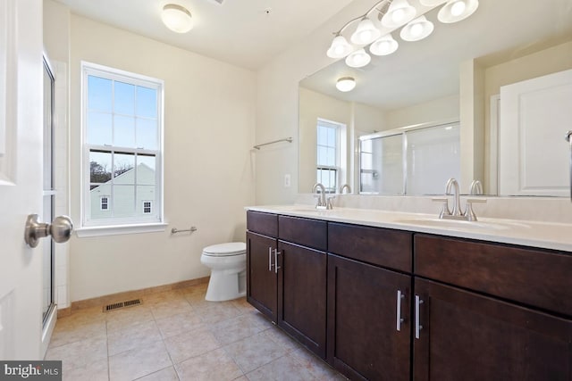 bathroom with tile patterned flooring, visible vents, a sink, and double vanity