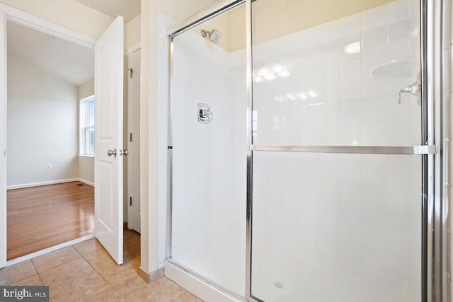 full bathroom with a stall shower and tile patterned floors