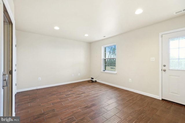 foyer entrance with dark wood-style flooring, recessed lighting, visible vents, and a healthy amount of sunlight