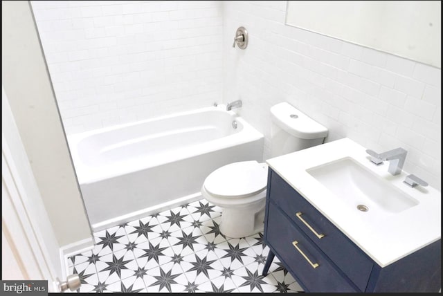 bathroom with bathing tub / shower combination, toilet, tile walls, and vanity