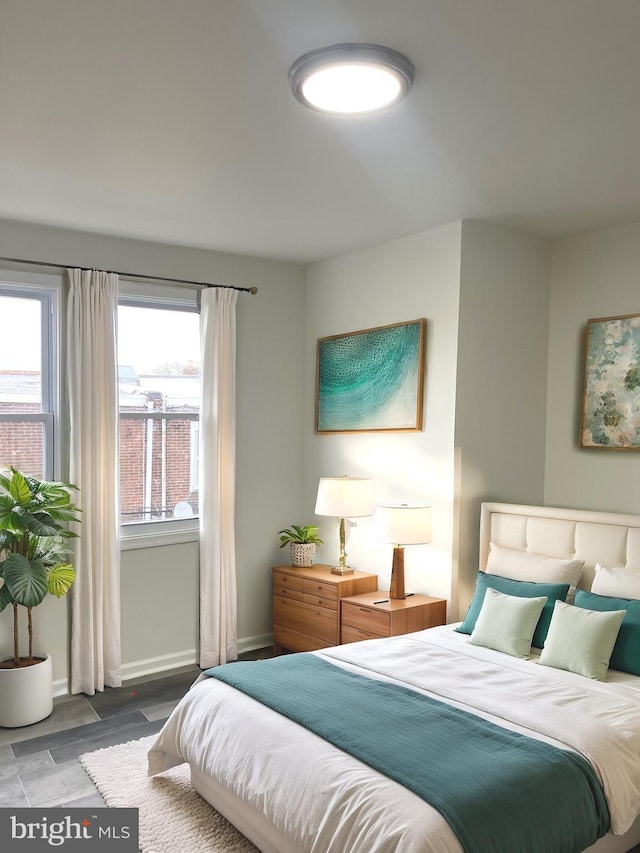 bedroom featuring baseboards and wood finished floors