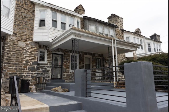 exterior space featuring stone siding