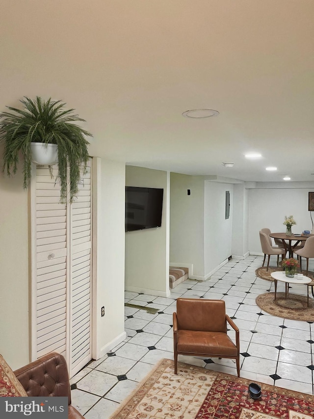 living area with light tile patterned floors and baseboards