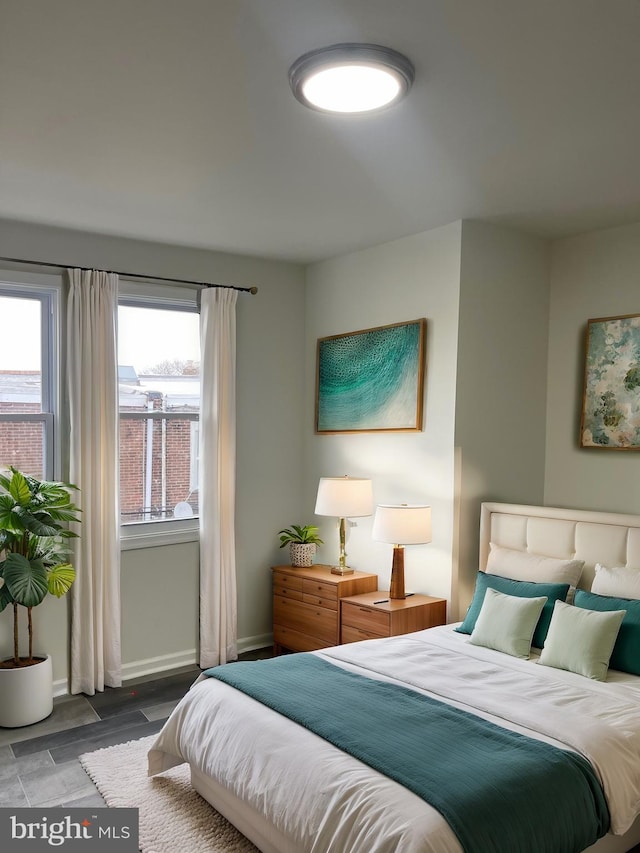 bedroom with baseboards and wood finished floors