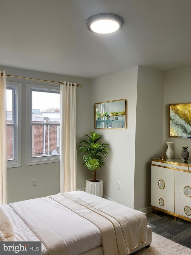 bedroom featuring dark wood finished floors